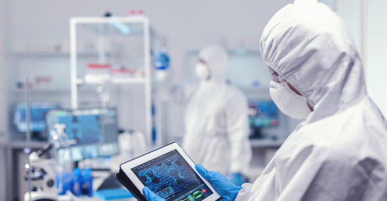 Concentrated medical researcher using digital tablet